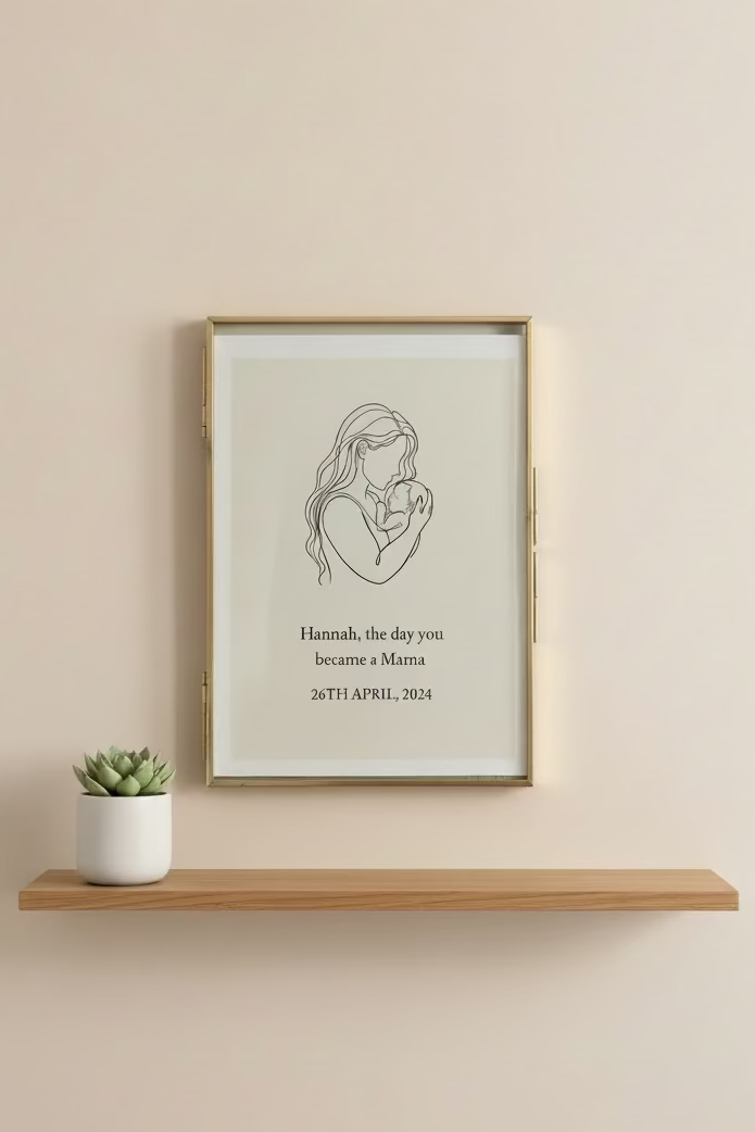 Framed artwork of a mother holding a baby with personalized text on a neutral background
